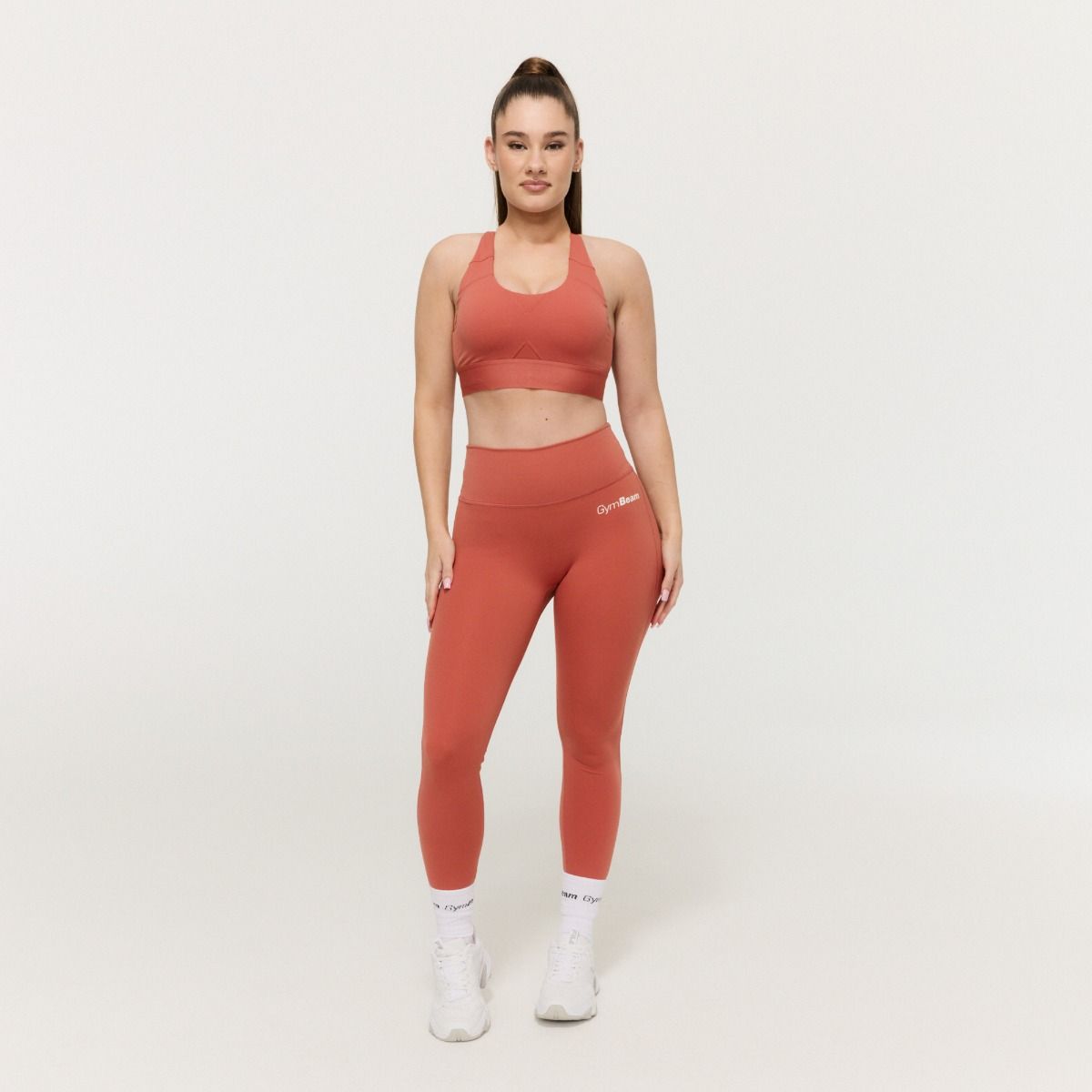 GYMBEAM - NŐI LIMITLESS SPORTMELLTARTÓ CINNAMON - NARANCSSÁRGA